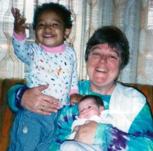 An nun cares for two young children at a Catholic Worker House.