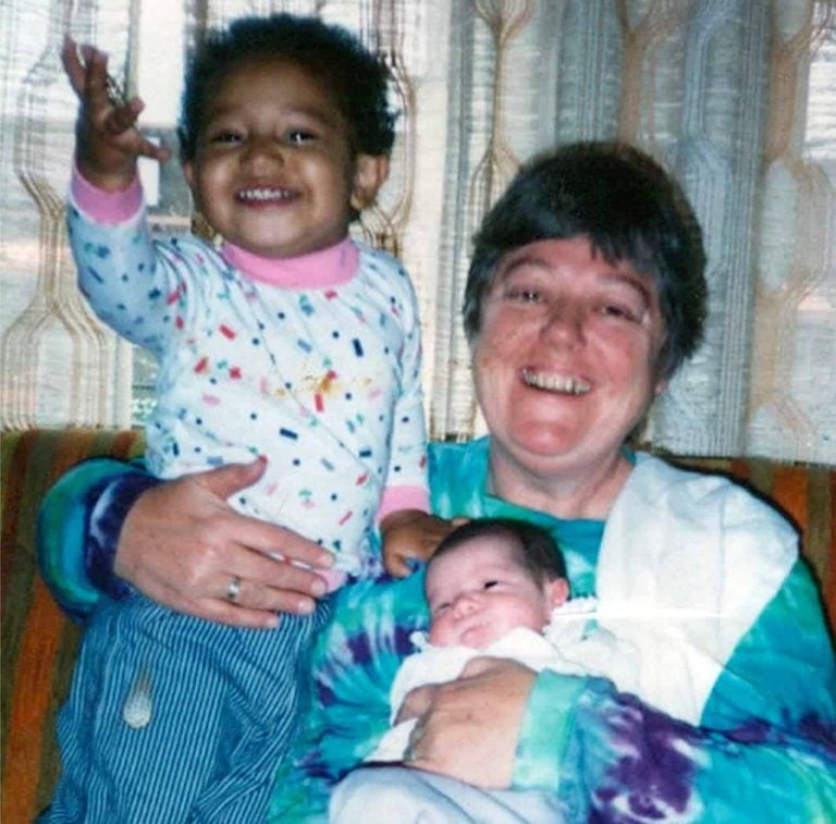 An nun cares for two young children at a Catholic Worker House.