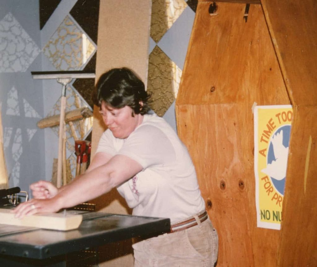 A young woman is show crafting pine coffins in a photo from the 1970s.