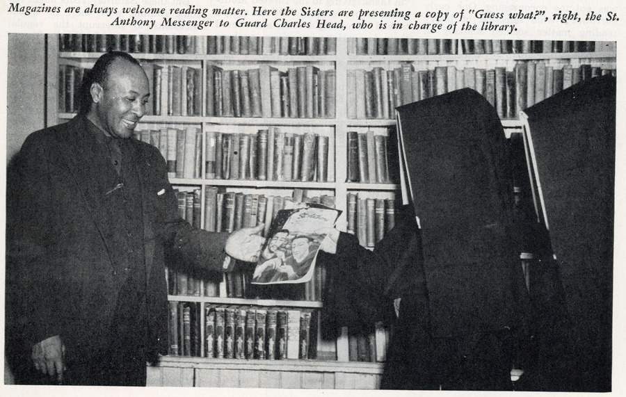 Archival news clipping of a photo of two nuns in habits handing a magazine to a Black man in a suit standing in front of a wall of bookshelves. The caption across the top reads "Magazines are always welcome reading matter. Here the Sisters are presenting a copy of 'Guess what?', right, the St. Anthony Messenger to Guard Charles Head, who is in charge of the library.