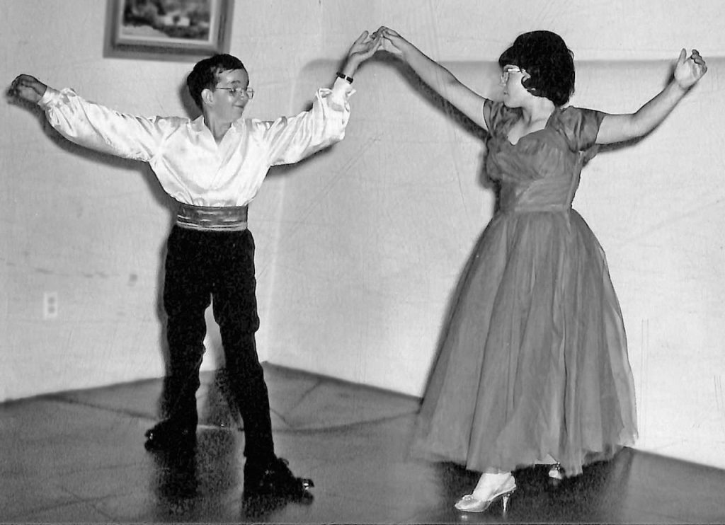 A black and white photo of two middle school students practicing for a dance recital.
