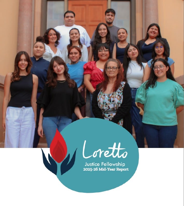 A group photo of 16 people of different ages, genders and backgrounds taken on the front steps of a building.