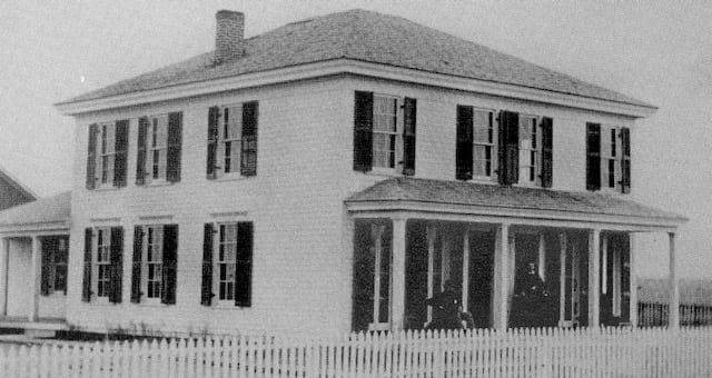 A black and white photo of a house that was the original school building of St. Mary's Academy in Denver.