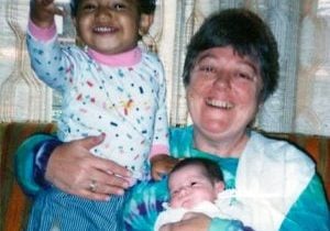 An nun cares for two young children at a Catholic Worker House.