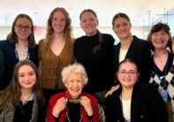 A group of high school students and three adults smiling for a picture together at the United Nations Commission on the Status of Women 2026.