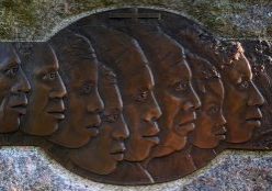 Carved faces on a bronze plate mark the Slave Memorial at the Loretto Motherhouse.